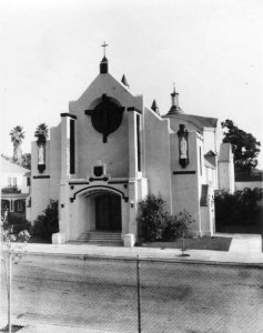 Exterior view of St. Dominic Catholic Church. St. Dominic's Catholic school was founded in 1925, dedicated on February 24th, and officially opened on September 8th, of that year. By 1940, as the congregation and the city's population boomed, construction for a new church building began, and the church opened for public worship on Rosary Sunday, 1941 at its current location (seen here).