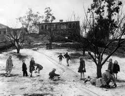 A group of children from St. Dominic's School found a way to take real advantage of the snow on January 10, 1945, by making a toboggan course in the 1800 block on Chickasaw Street, Eagle Rock, for sleds, boards, or anything else that could be slid on.
