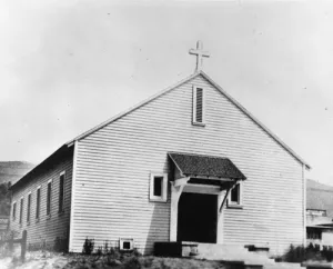 Prior to this first building, services were being held in tents that had been set up on two lots that had been purchased on Merton Ave. in the heart of Eagle Rock's valley. By 1925, as the city's population boomed, a new church complex as well as a school and convent were built on the same location. View of the temporary wooden chapel of St. Dominic Catholic Church, built 1921, and subsequently known as the "Old Hall" and later "DePorres Hall".