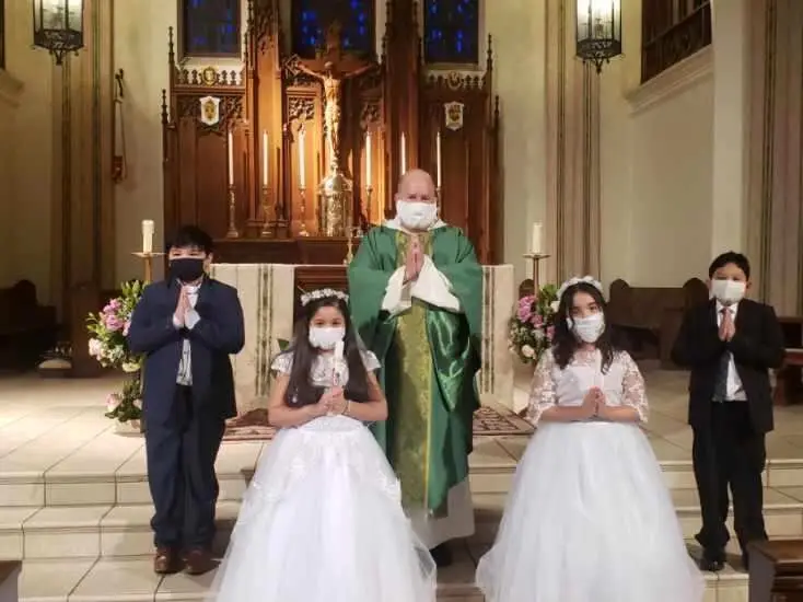 St. Dominic students and priest in church